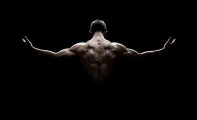 Powerful back shot of a fit individual. with toned muscles, ideal for fitness transformation and gym inspiration. 90s bodybuilder. https://karanblog.in/